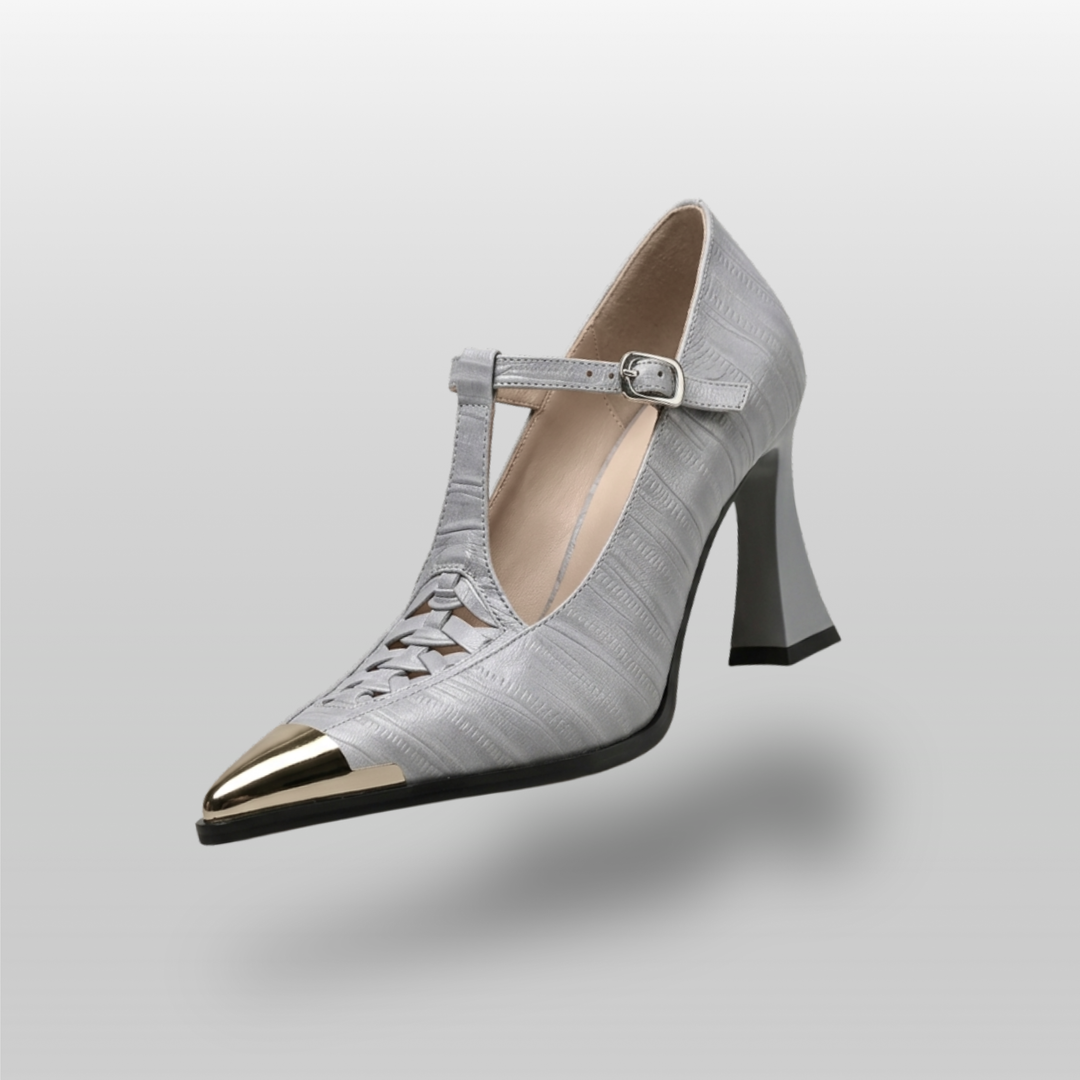 Silver high-heeled shoe with a pointed toe on a gray background