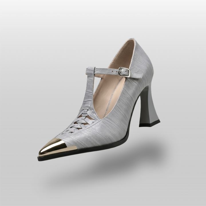 Silver high-heeled shoe with a pointed toe on a gray background