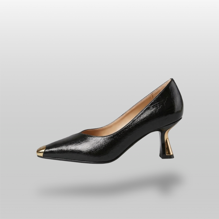 Black high-heeled shoe with gold accents on a gray background