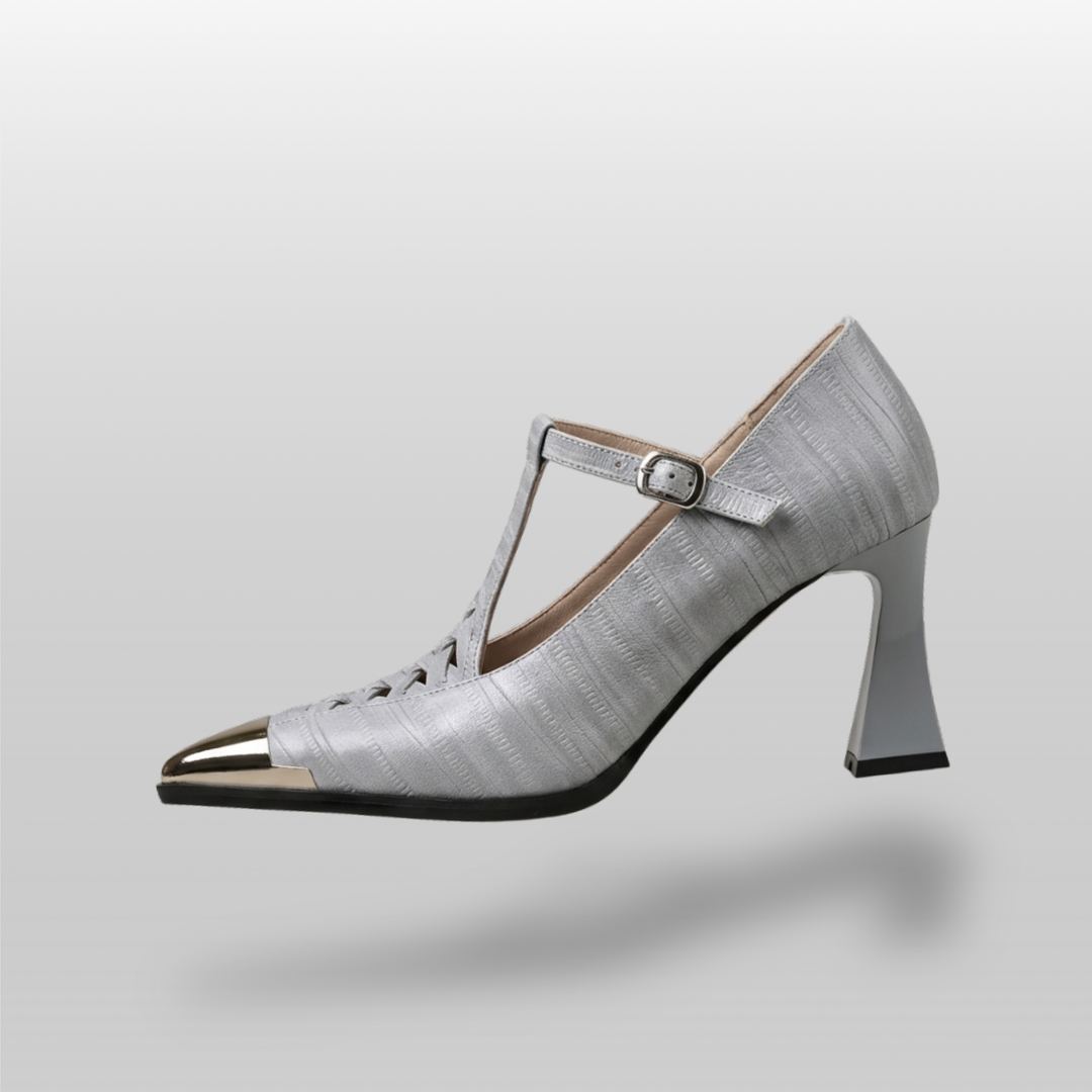 Silver high-heeled shoe with a strap on a light gray background