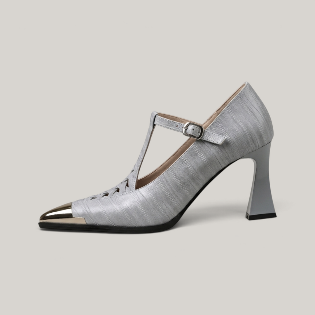Silver high-heeled shoe with a strap on a light gray background