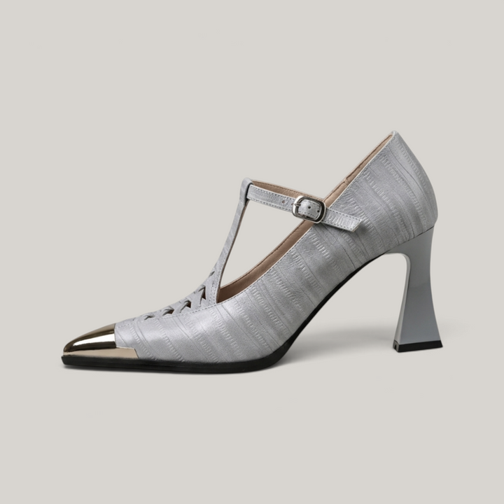 Silver high-heeled shoe with a strap on a light gray background