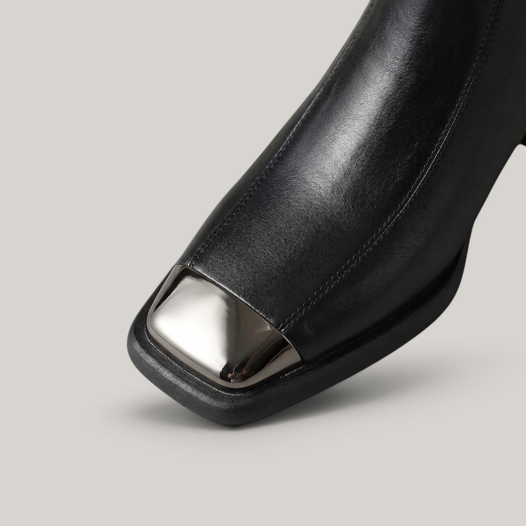 USS® Shoes Valenne black cowhide leather ankle boots featuring a square toe with a polished silver metal cap detail.