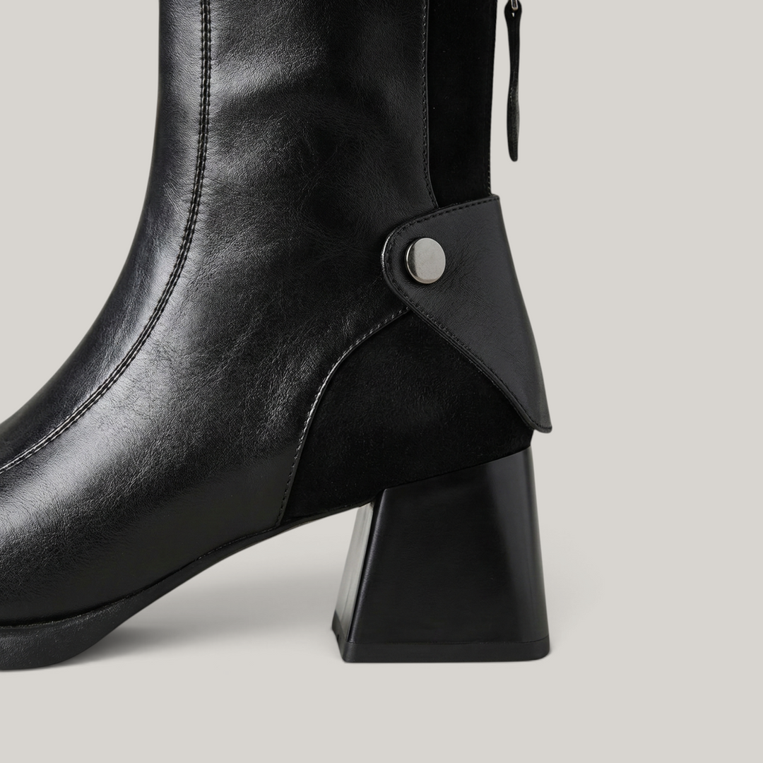 USS® Shoes Valenne black leather ankle boots featuring a sculpted block heel and polished metal side detail