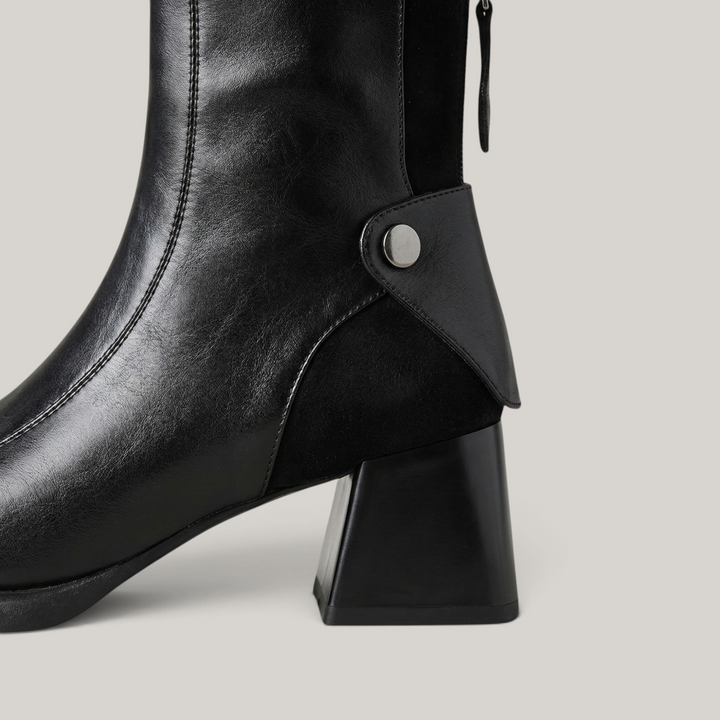 USS® Shoes Valenne black leather ankle boots featuring a sculpted block heel and polished metal side detail