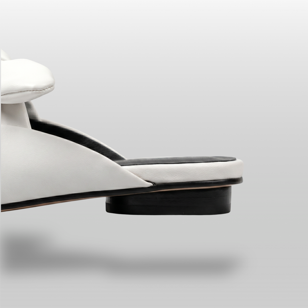 Bianca Knot Mule in Bianco Latte heel detail with open-back mule construction and black sole edge