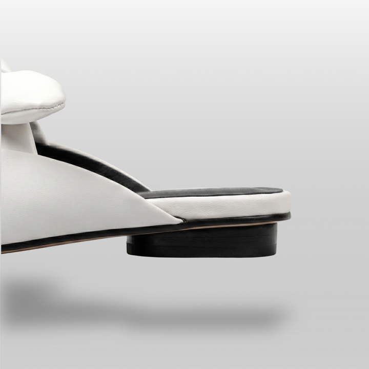 Bianca Knot Mule in Bianco Latte heel detail with open-back mule construction and black sole edge