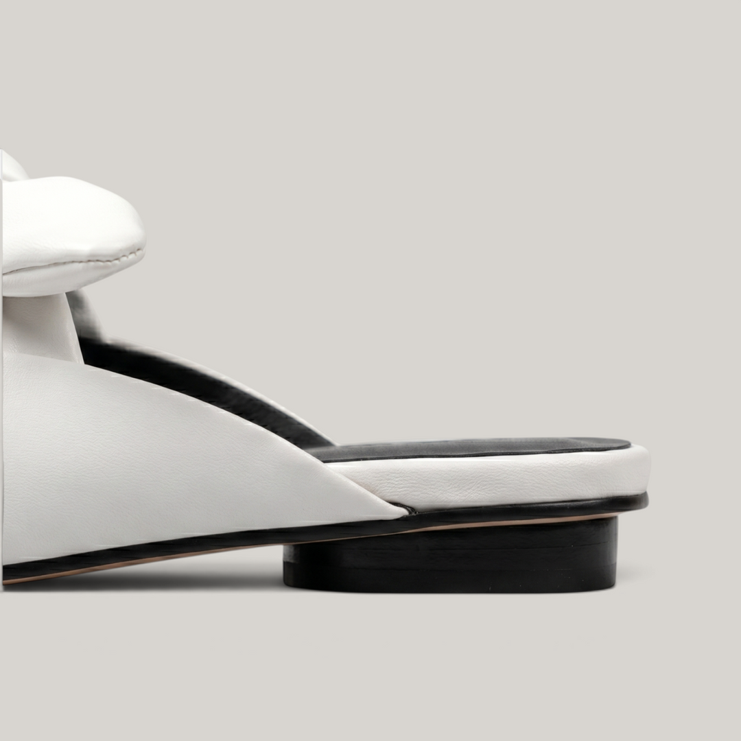 Bianca Knot Mule in Bianco Latte heel detail with open-back mule construction and black sole edge