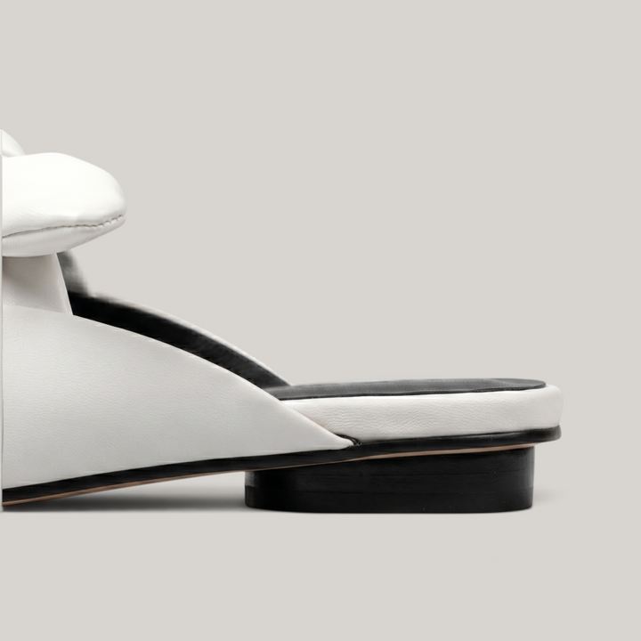 Bianca Knot Mule in Bianco Latte heel detail with open-back mule construction and black sole edge