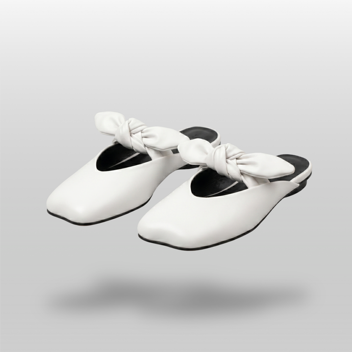 Bianca Knot Mule in Bianco Latte pair shot in luxury studio with knot detail and color block sole