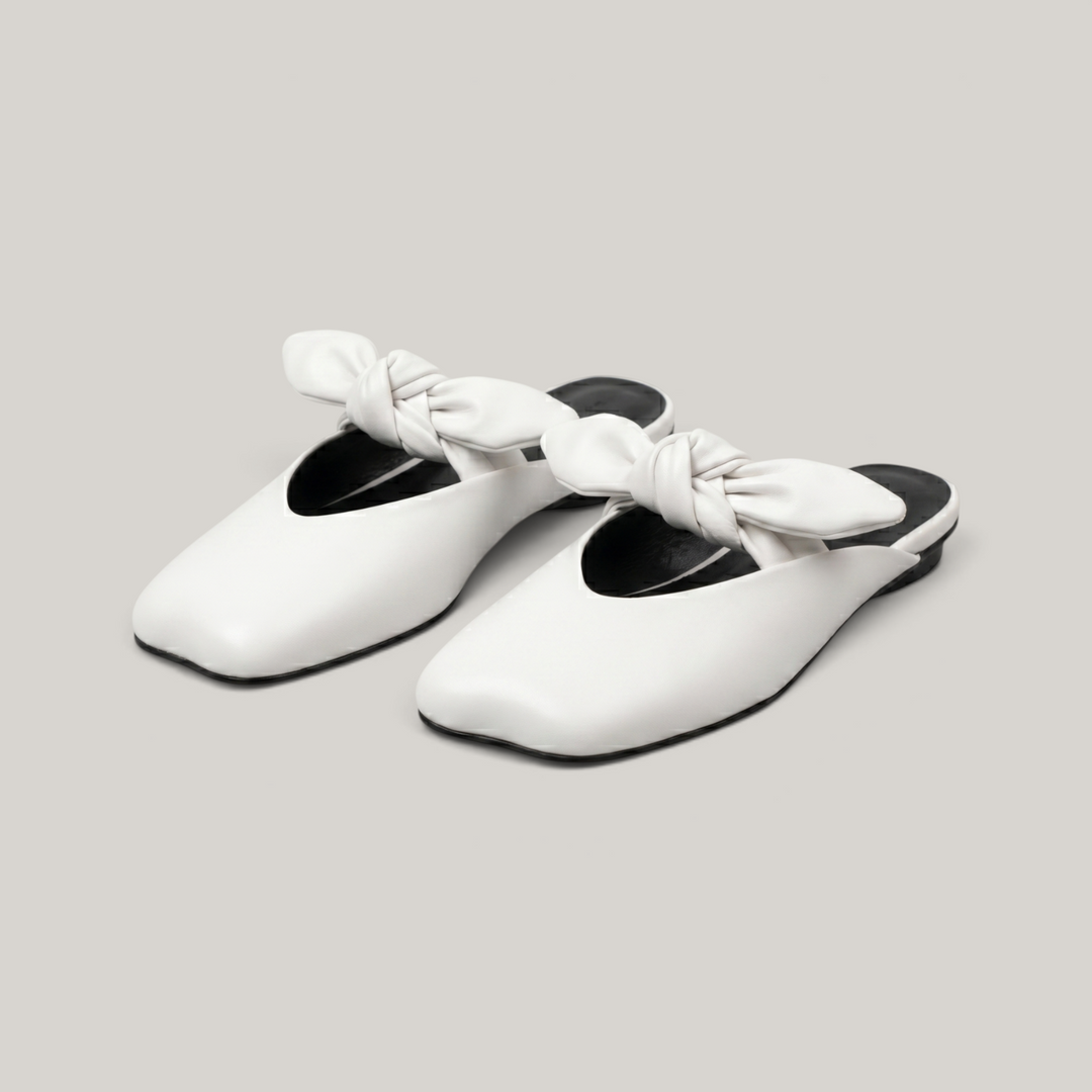 Bianca Knot Mule in Bianco Latte pair shot in luxury studio with knot detail and color block sole