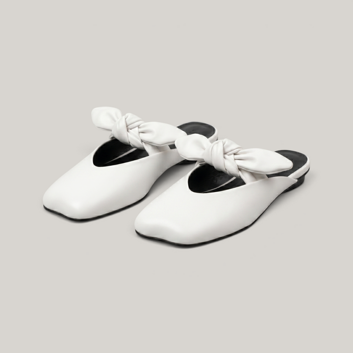 Bianca Knot Mule in Bianco Latte pair shot in luxury studio with knot detail and color block sole