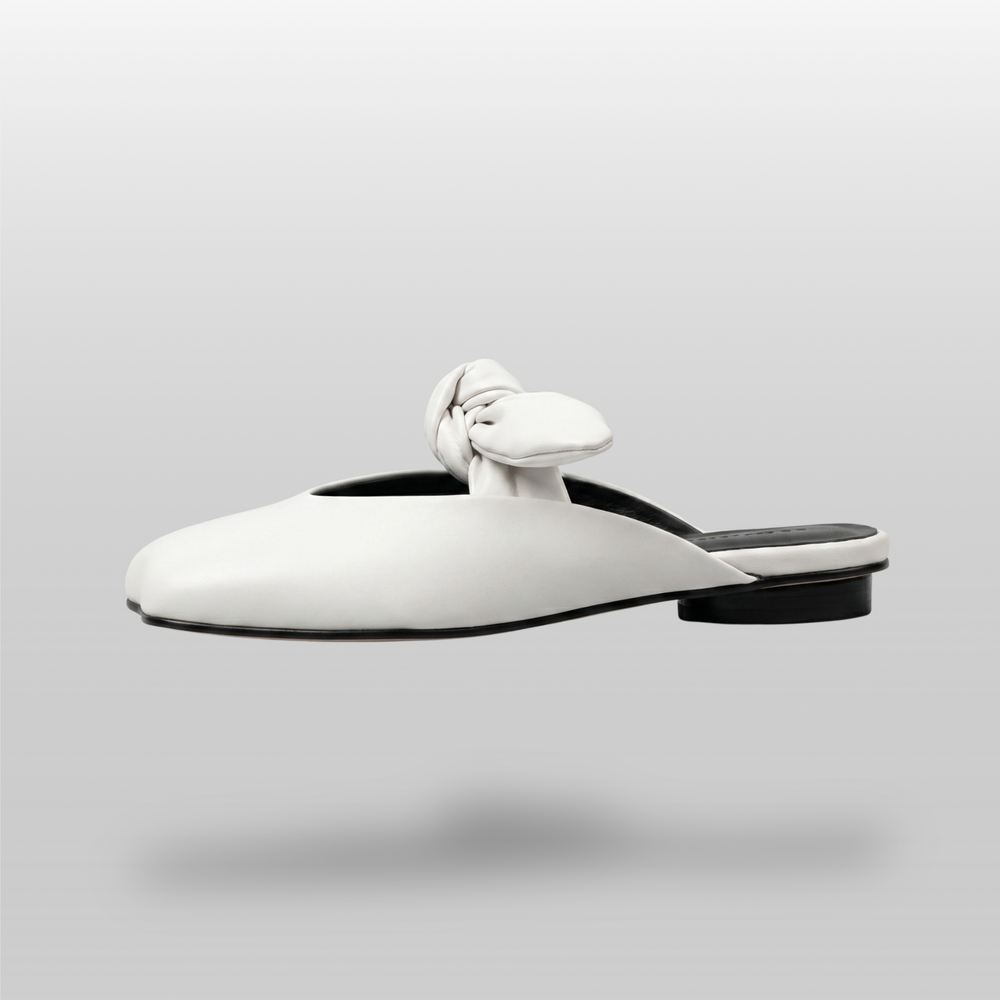 Bianca Knot Mule in Bianco Latte side profile showing flat sole and open-back mule silhouette