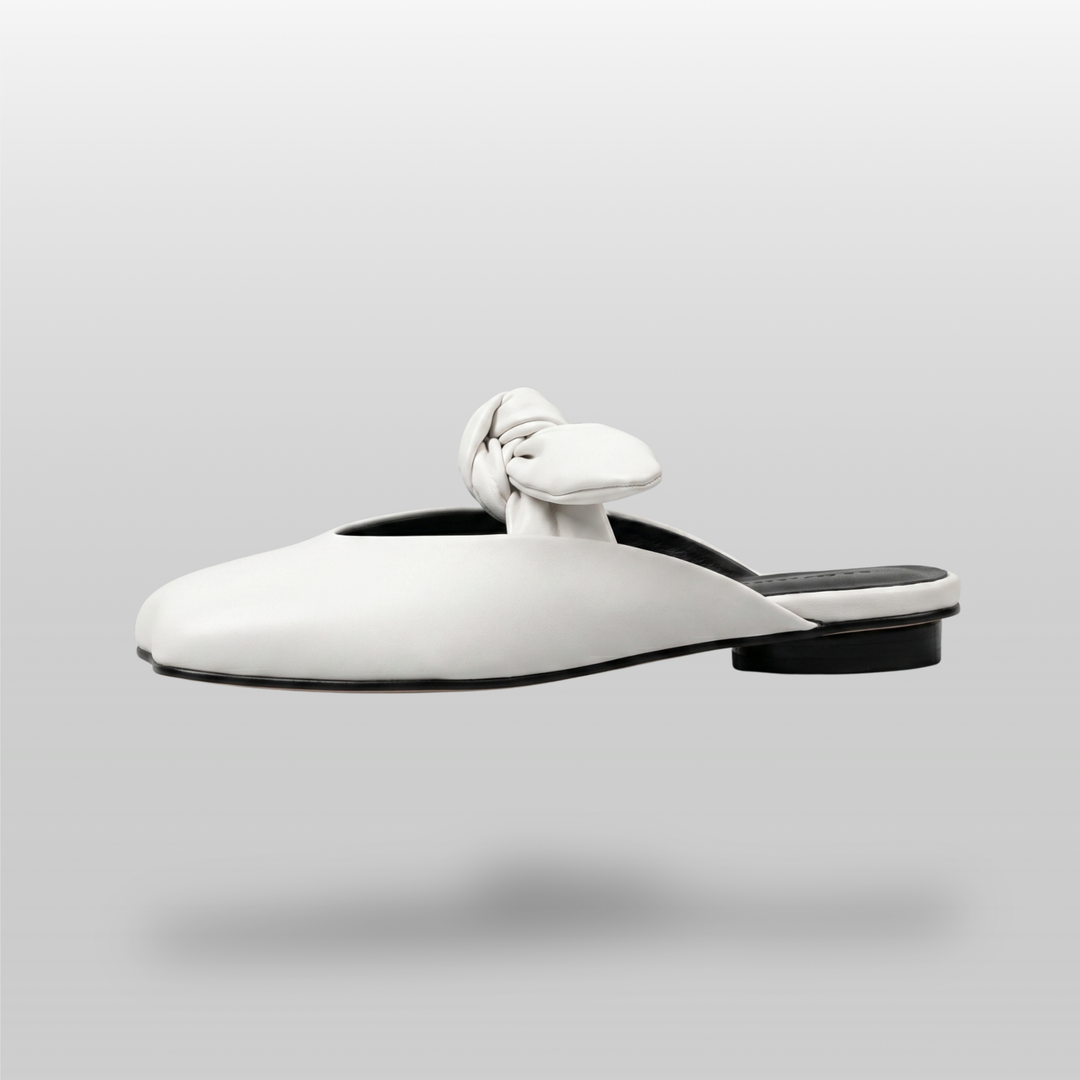 Bianca Knot Mule in Bianco Latte side profile showing flat sole and open-back mule silhouette