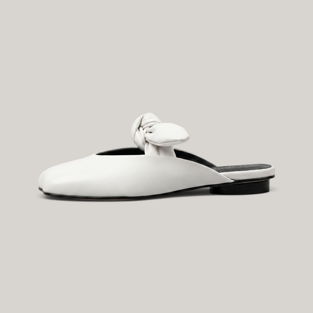Bianca Knot Mule in Bianco Latte side profile showing flat sole and open-back mule silhouette
