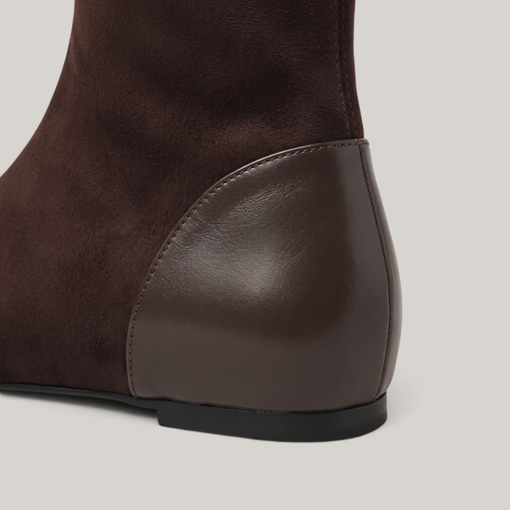 Close-up of curved leather heel counter and thin dark sole edge