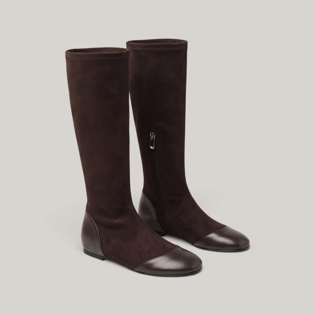 Pair of brown knee-high boots showing side zip and leather toe caps