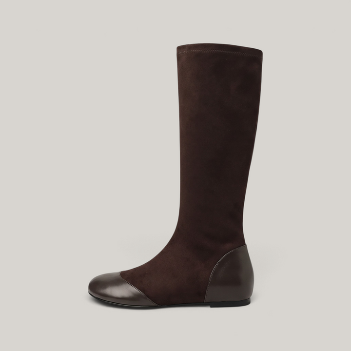 Side profile of brown knee-high boot with flat continuous sole line