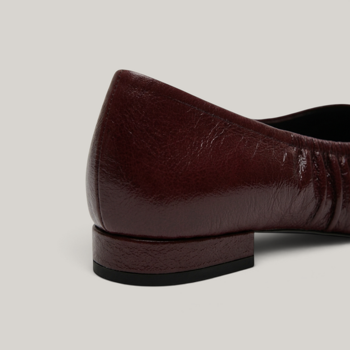 USS® Shoes Colette flat in bordeaux profond crinkled patent leather with a low stacked block heel and ruched detail