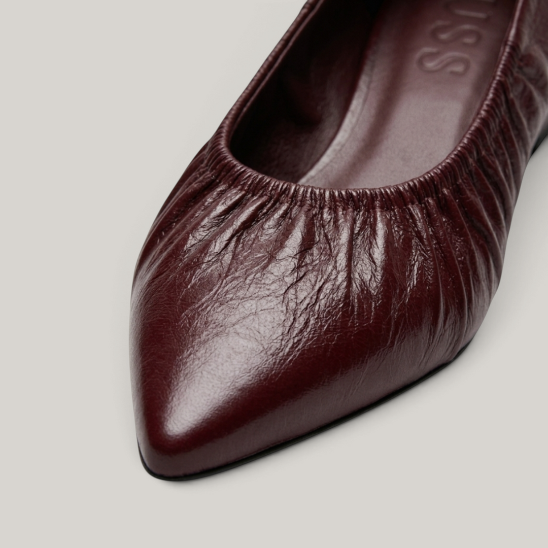 USS® Shoes Colette flat in bordeaux profond crinkled patent leather with an elasticated ruched pointed toe design.