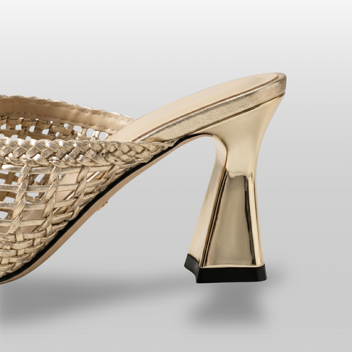 Dorée Mule in Or Tissé. Architectural 7.5cm trapezoidal block heel in metallic gold with black rubber base.
