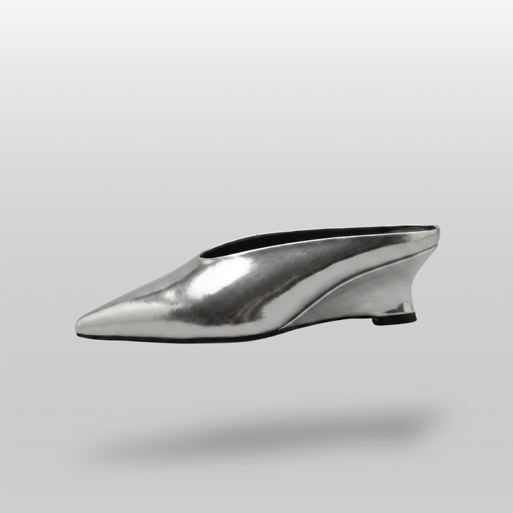 Side profile of the silver Argent Vif Lumière Mule, showcasing its sleek silhouette and geometric heel.