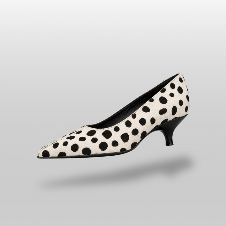 Ivory and black spotted pointed pump with curved black kitten heel
