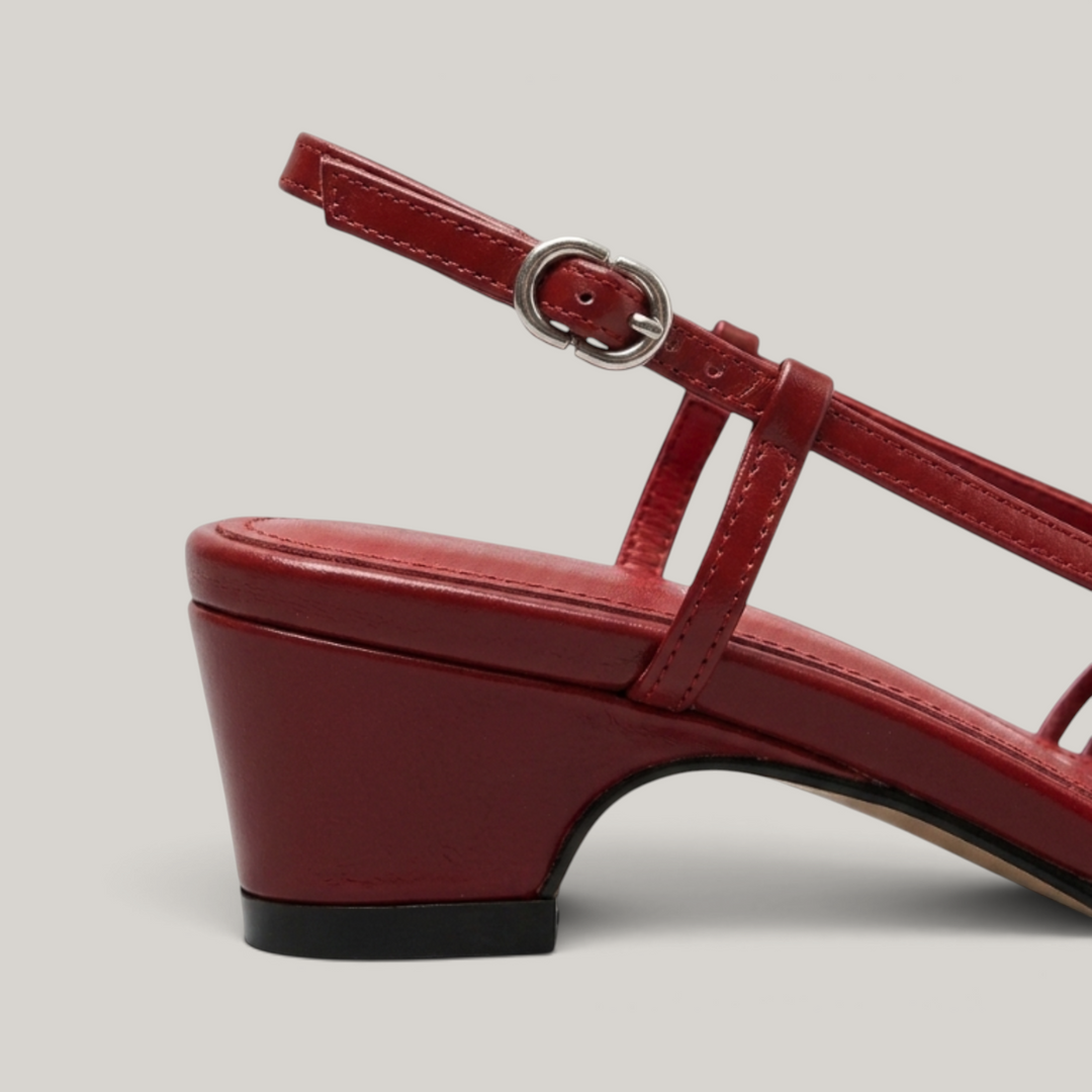Side view close-up of the Margot Slingback in Rouge Claret, highlighting the low block heel and adjustable silver buckle strap.