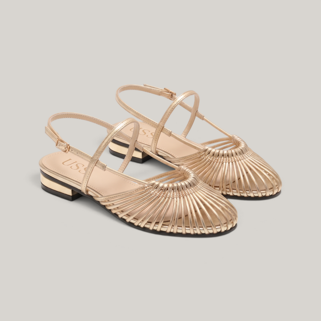 Pair of gold woven flat sandals with radiating vamp and ankle straps