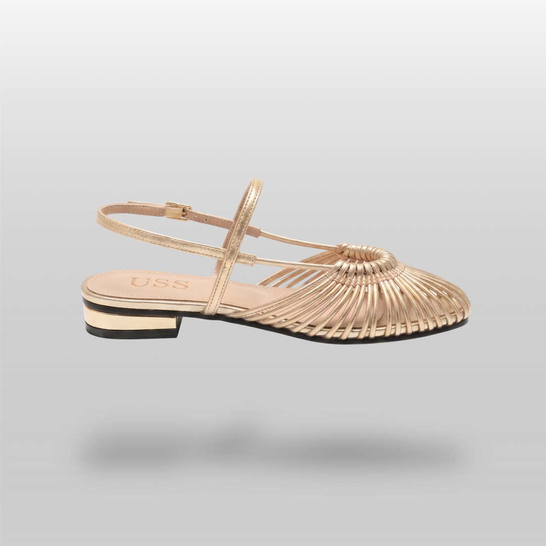 Side profile of gold woven flat sandal with gold-trimmed block heel