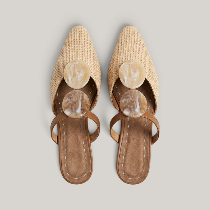 Paloma Mule in Sable Doré. Close detail of two oval resin medallions in marbled cream and caramel with natural translucency.
