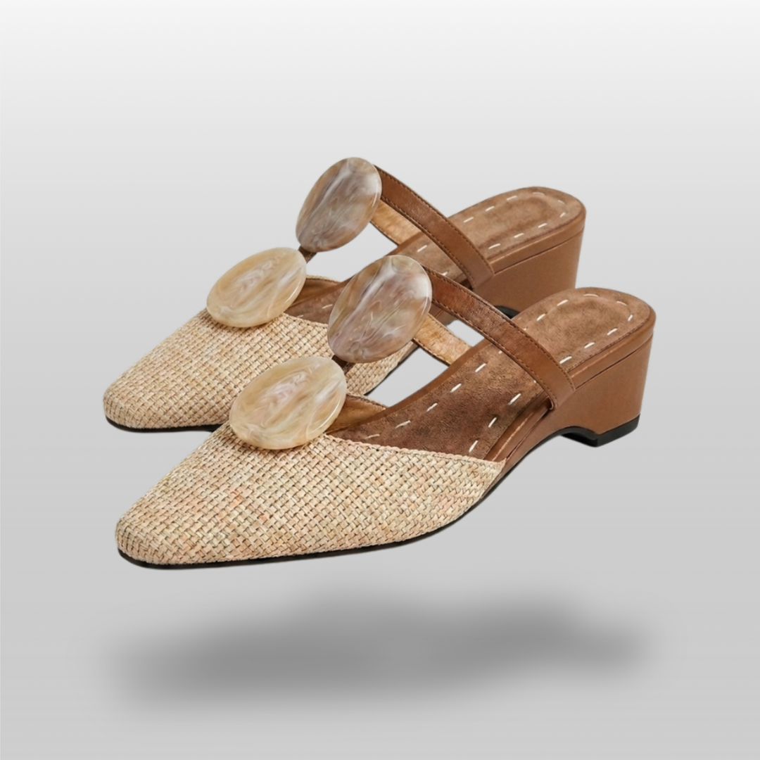 Paloma Mule in Sable Doré. Pair of raffia and camel leather mules with marbled resin medallion detail and low wedge heel.
