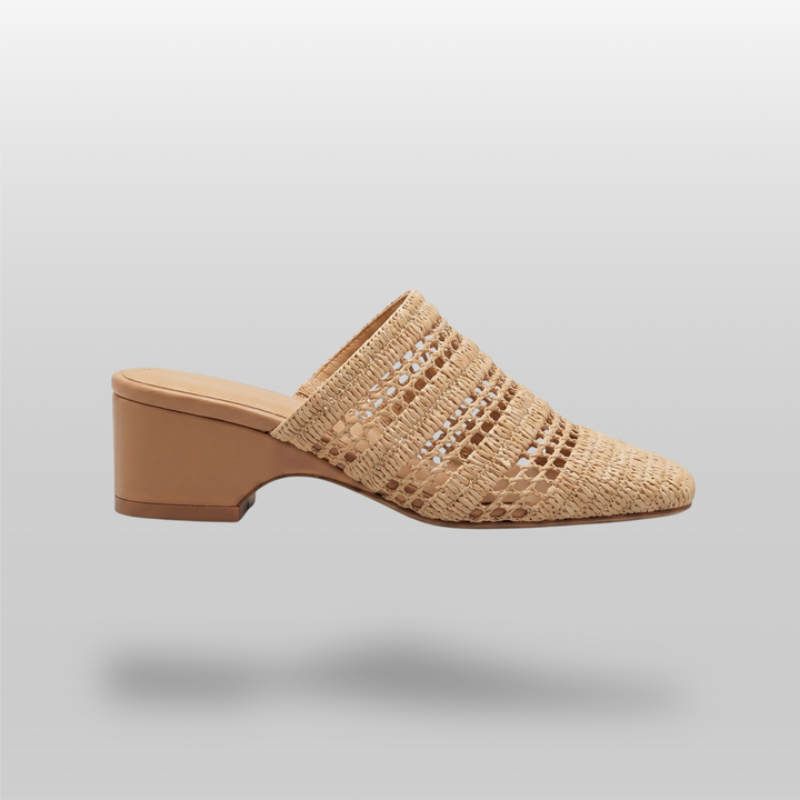 Side view of the Riviera Mule in Sable Naturel, featuring an open raffia weave, square toe silhouette, and a 6cm block heel.