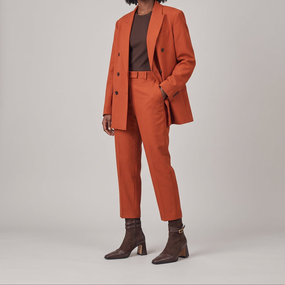 Romy Bootie in Brun Noisette worn with a rust tailored suit and a chocolate brown top