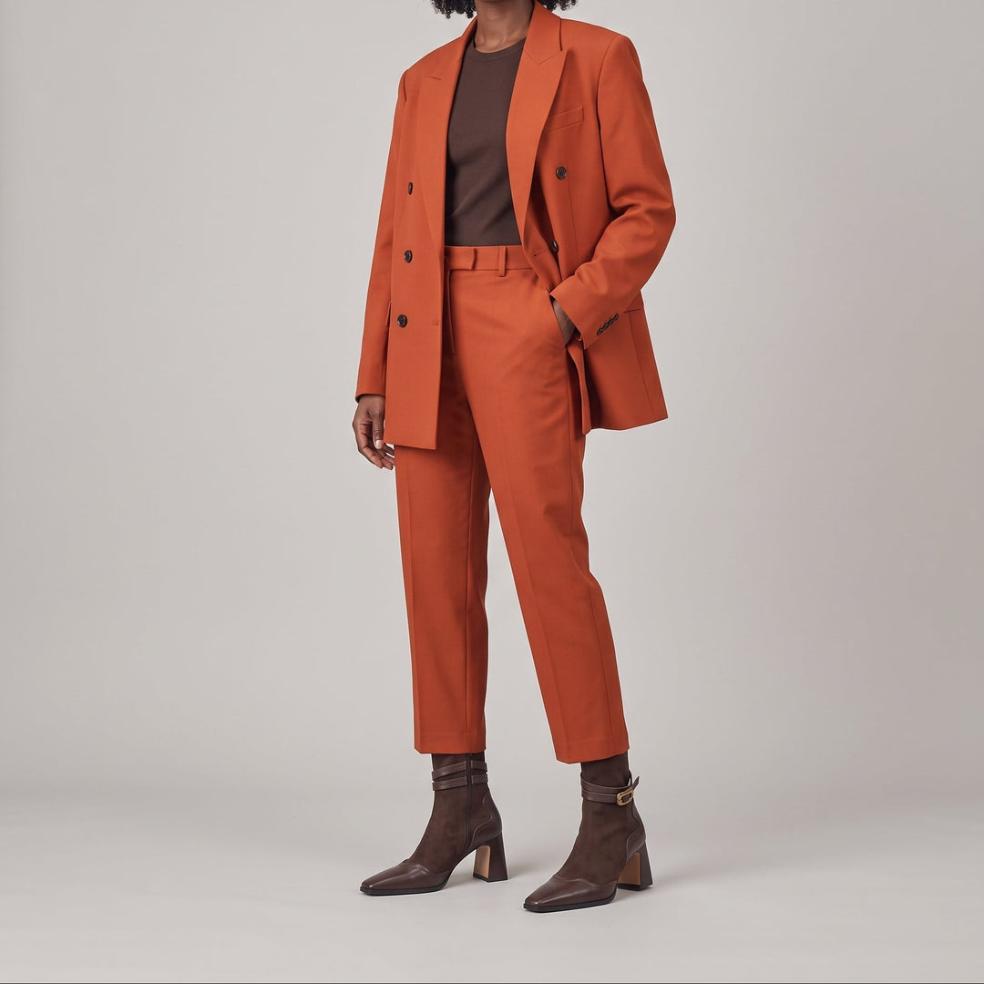 Romy Bootie in Brun Noisette worn with a rust tailored suit and a chocolate brown top