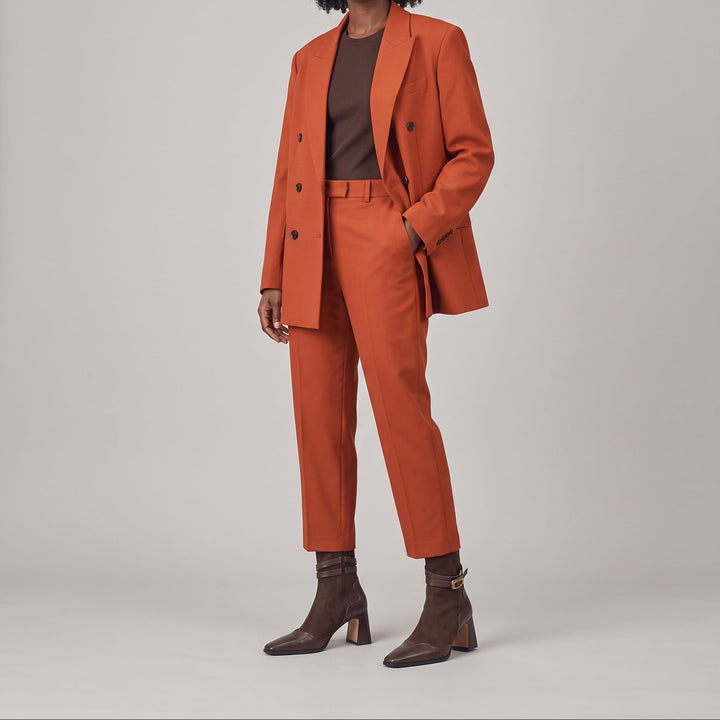 Romy Bootie in Brun Noisette worn with a rust tailored suit and a chocolate brown top