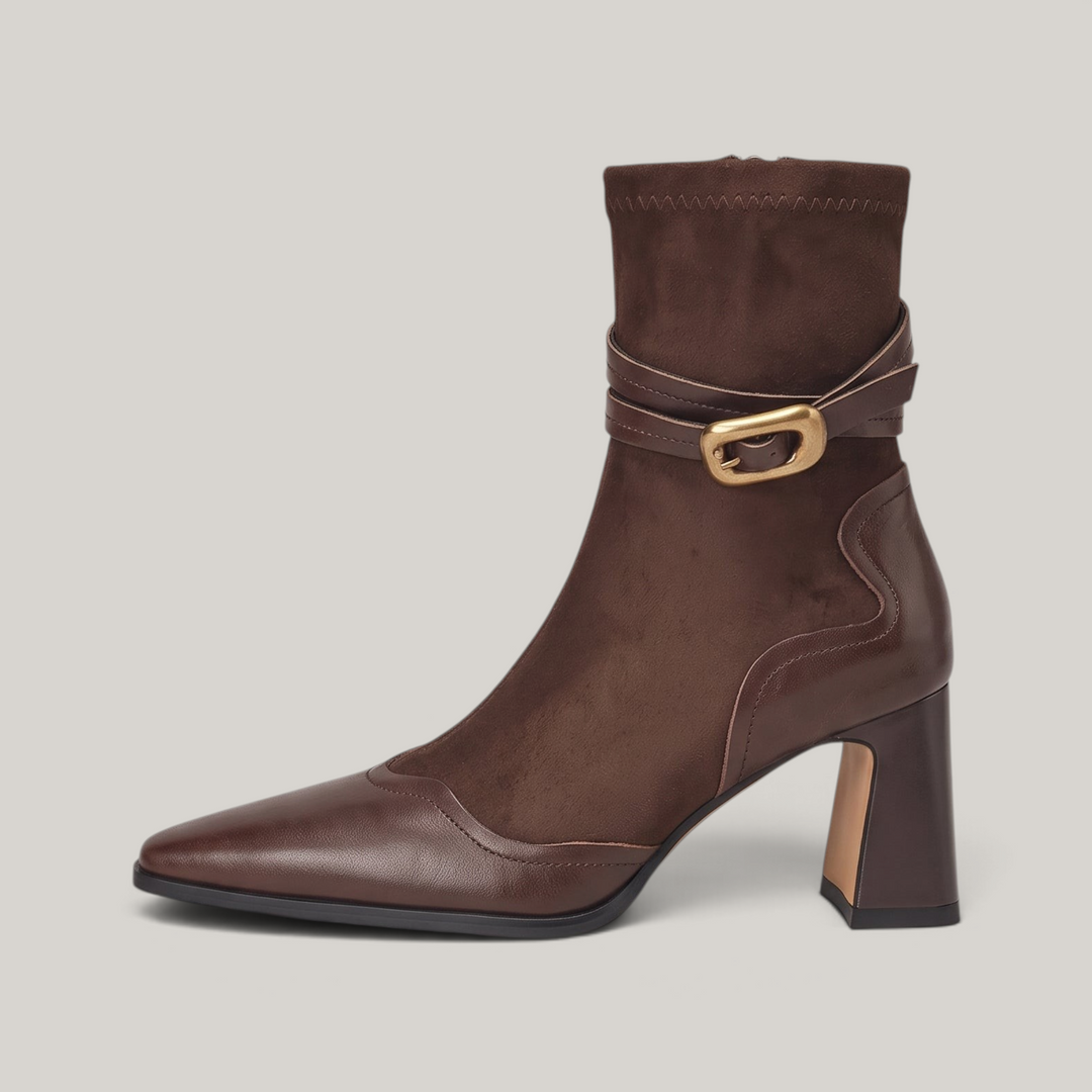 Side view of the Romy Bootie in Brun Noisette showing the flared block heel and wave-edge leather heel panel