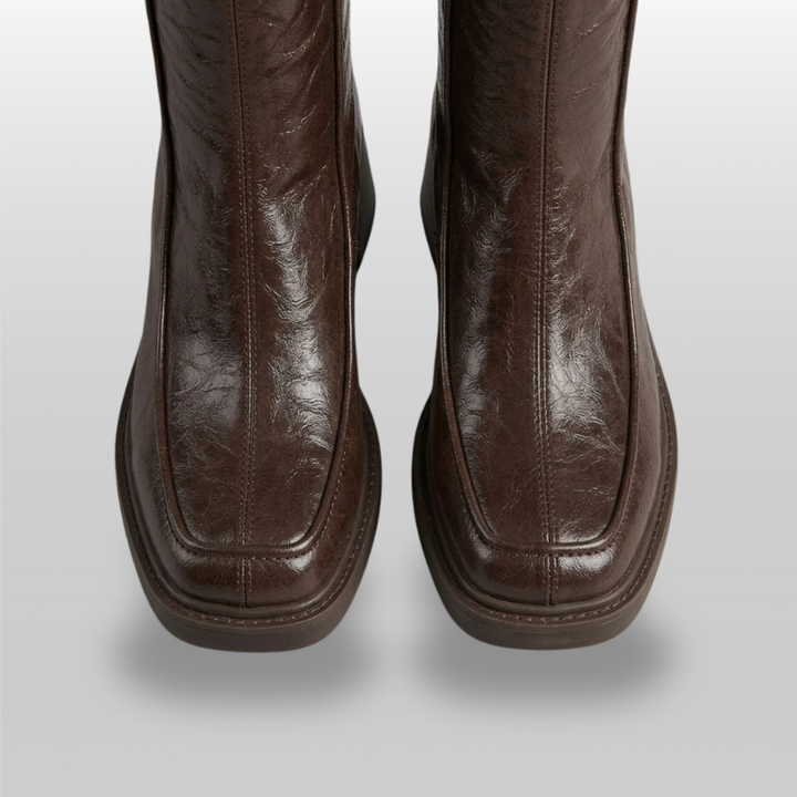 Close-up of moc-toe seam and squared toe on brown knee-high boots