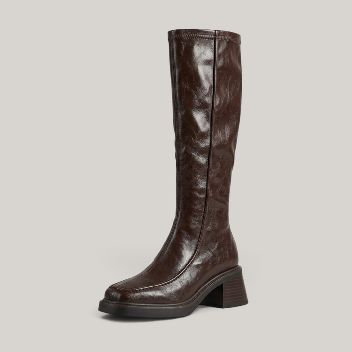 Brown knee-high stretch boot with moc-toe seam and stacked block heel