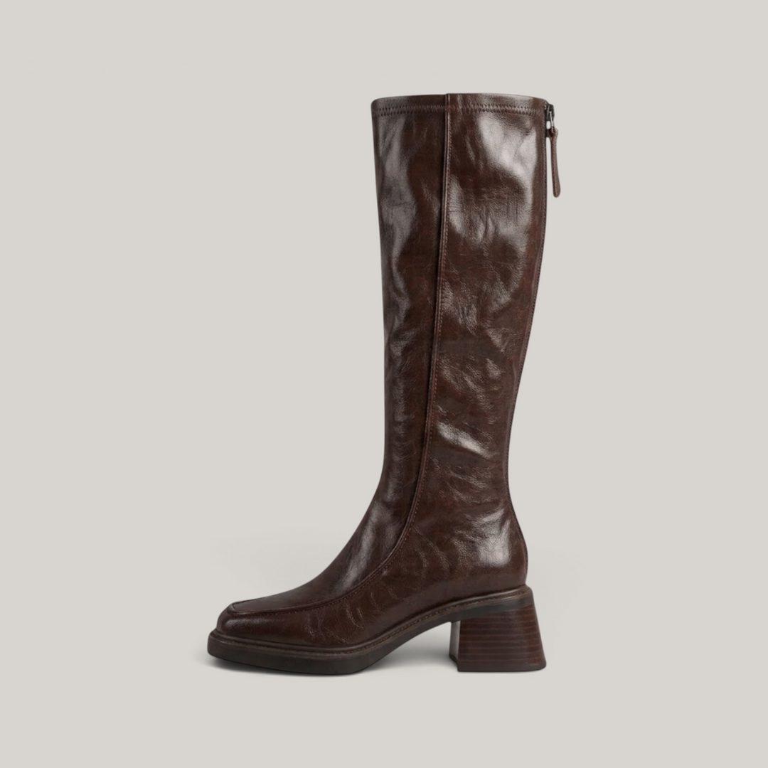 Side profile of brown knee-high boot showing full-length back zip