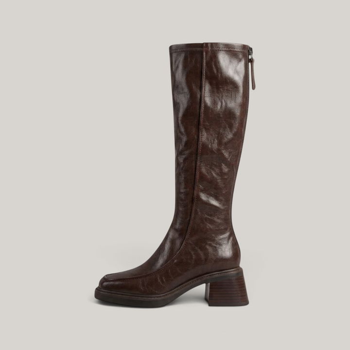 Side profile of brown knee-high boot showing full-length back zip