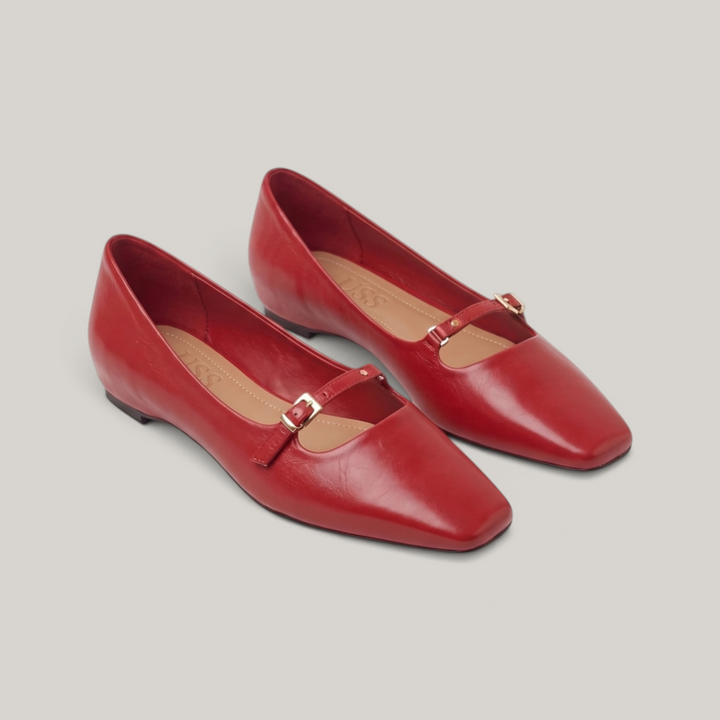 Pair of red square-toe Mary Jane flats with gold buckle straps