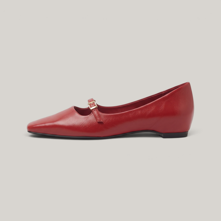 Side profile of red Mary Jane flat with flat continuous sole line