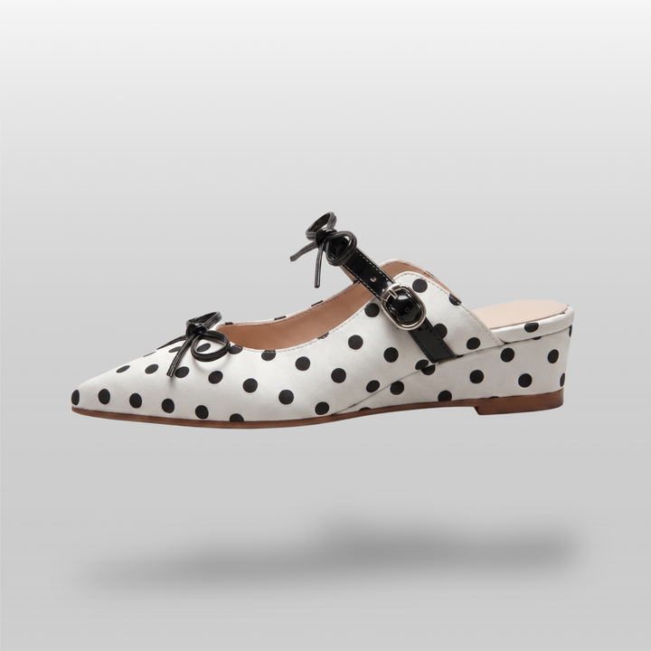 Side profile of the USS Elise Mule, showcasing the architectural chunky heel and the seamless transition of the polka dot leather pattern.