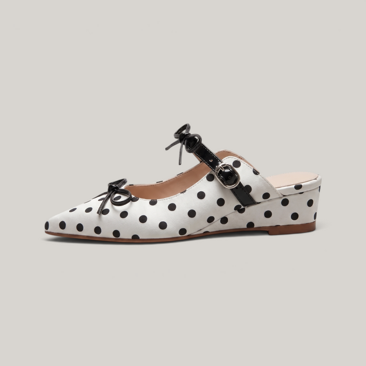 Side profile of the USS Elise Mule, showcasing the architectural chunky heel and the seamless transition of the polka dot leather pattern.
