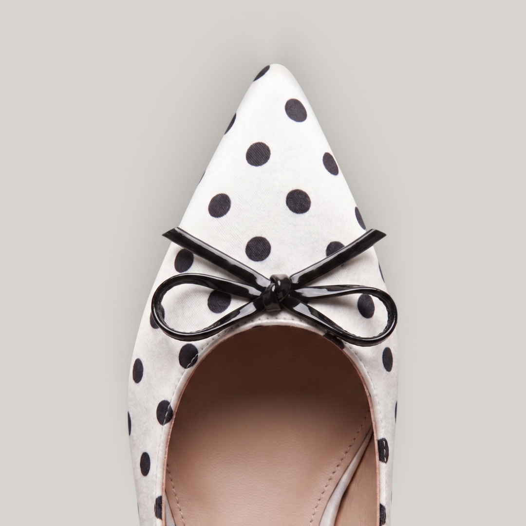 Close-up detail of the USS Elise pointed toe box, highlighting the high-quality leather grain and precision polka dot print.