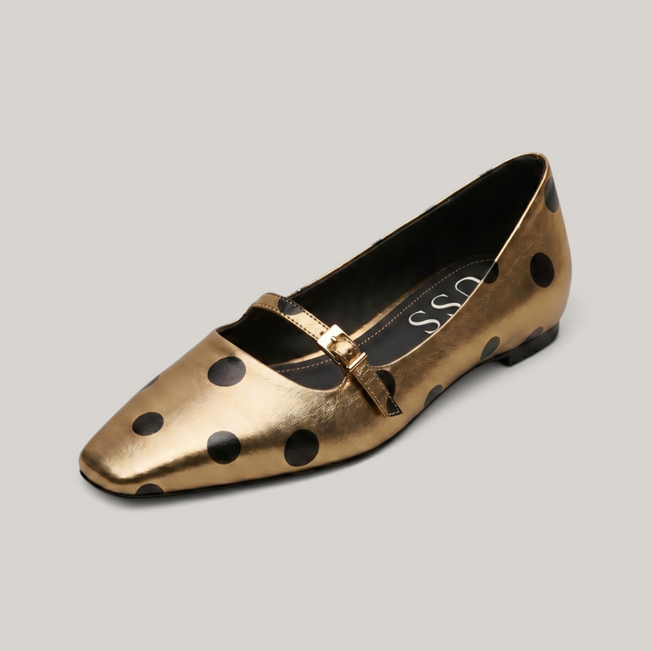 USS® Shoes Adeline gold metallic sheepskin Mary Jane with black polka dots, square toe, and adjustable strap.