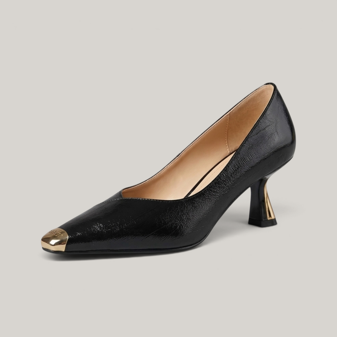 USS® Shoes Aurelle black sheepskin leather pumps with a sculpted heel and metallic pointed toe detail.