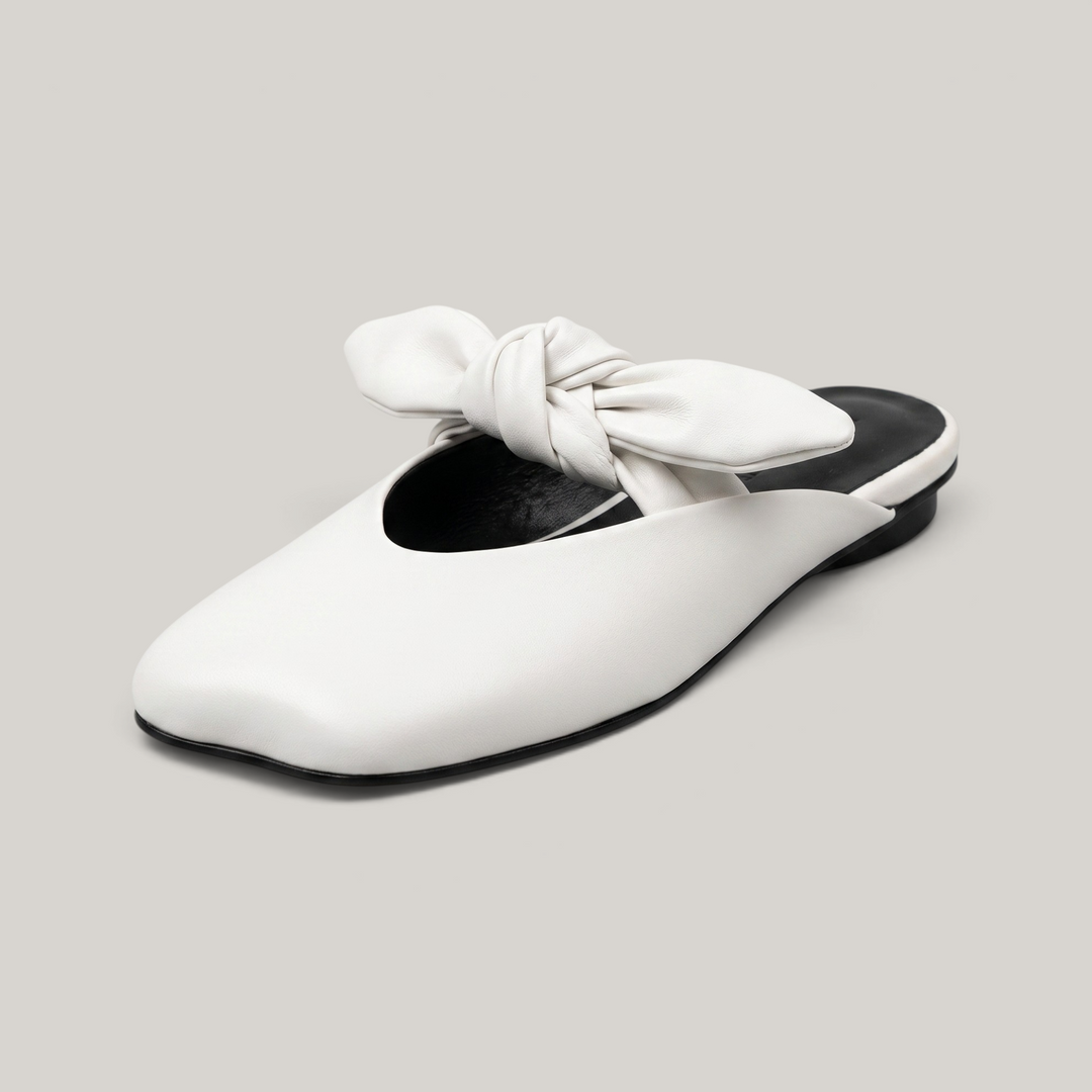 USS® Shoes Bianca Knot Mule in ivory leather with a sculptural knot detail, soft square toe, and black sole.