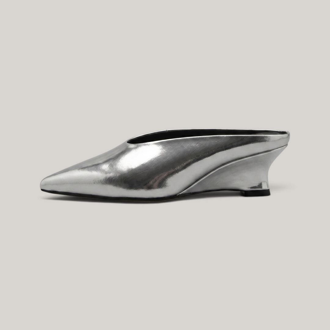 USS® Shoes Lumière mule in metallic silver leather with a sharp pointed toe and architectural kitten heel.